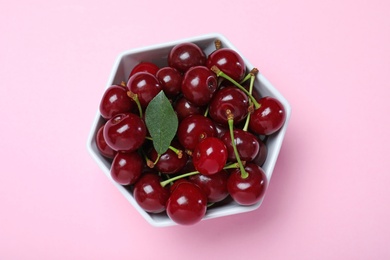 Photo of Sweet juicy cherries on pink background, top view