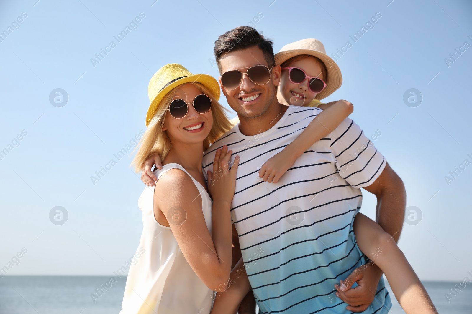 Photo of Happy family at beach on sunny summer day