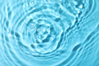 Photo of Closeup viewwater with rippled surface on light blue background