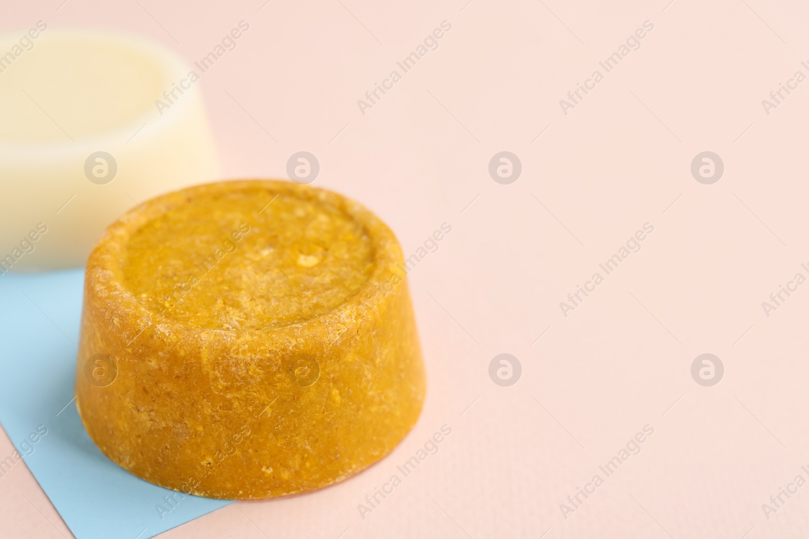 Photo of Solid shampoo bars on color background, closeup. Space for text