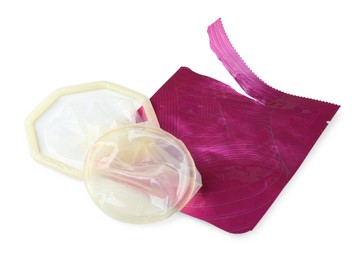 Photo of Unpacked female condom and torn package isolated on white. Safe sex