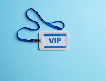 Photo of Plastic vip badge on light blue background, top view