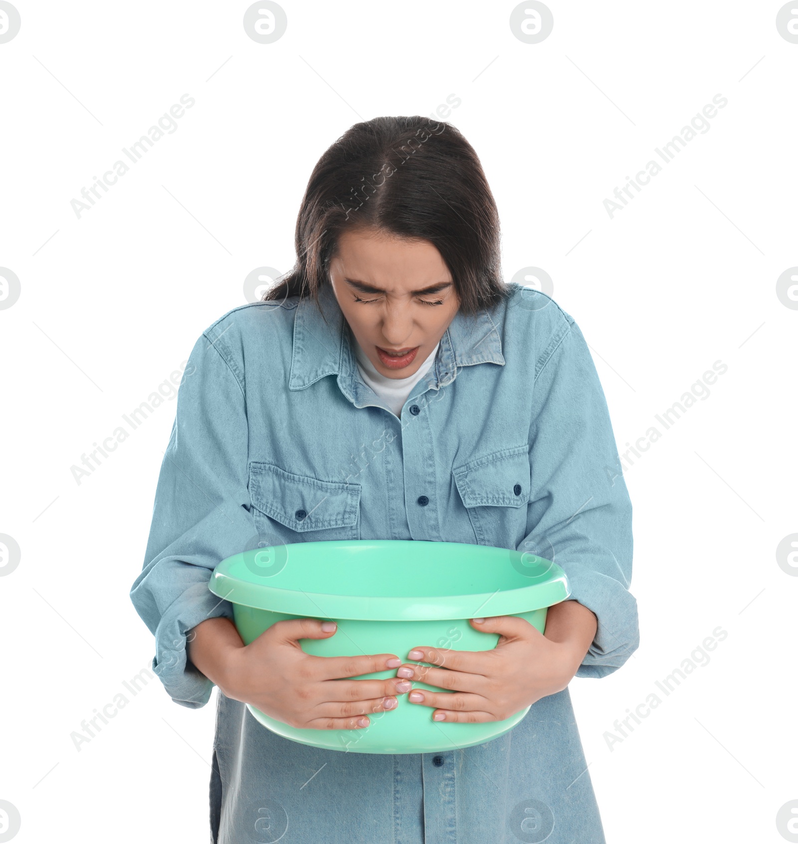 Photo of Young woman with basin suffering from nausea on white background. Food poisoning