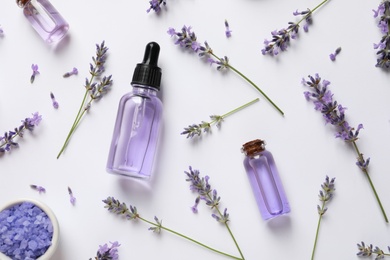 Composition with natural lavender cosmetic products and flowers on white background, top view