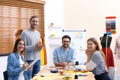 Photo of Fashion designers creating new clothes in studio