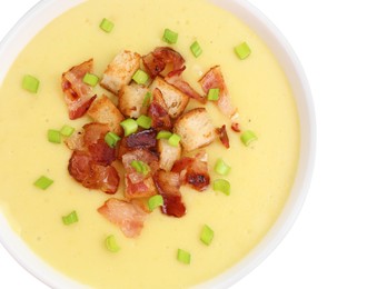 Photo of Tasty potato soup with bacon, croutons and green onion in bowl isolated on white, top view