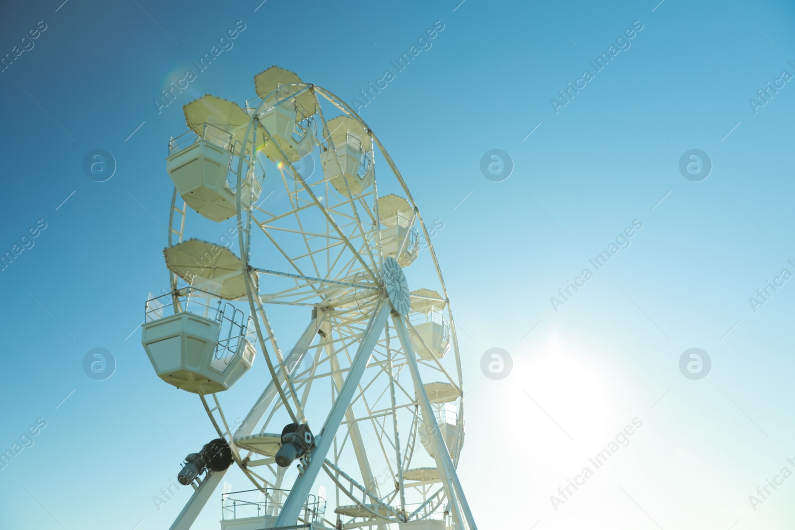 Photo of Large observation wheel against blue sky, space for text