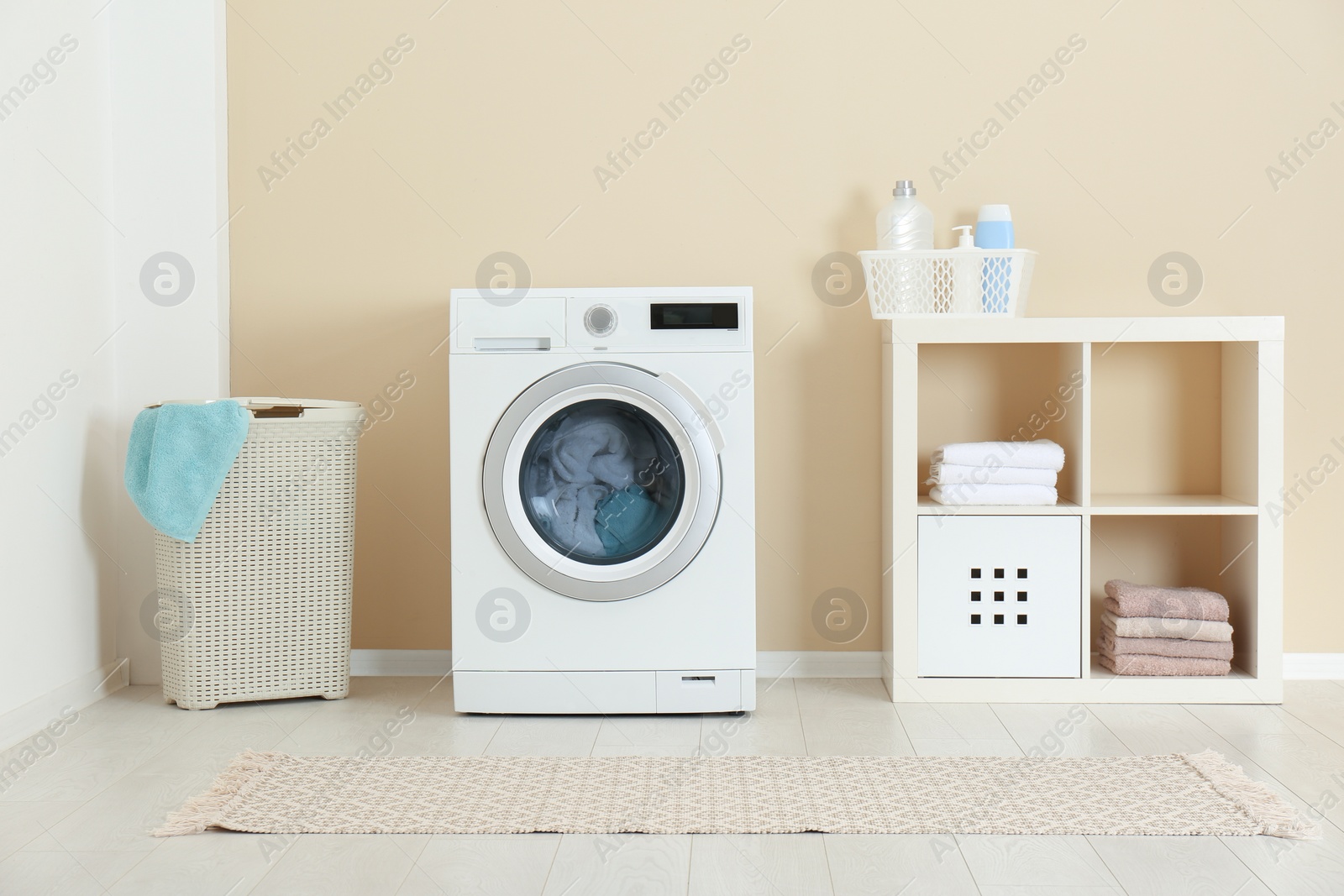 Photo of Washing of different towels in modern laundry room