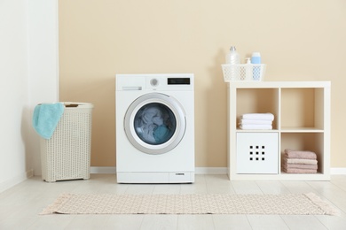 Washing of different towels in modern laundry room