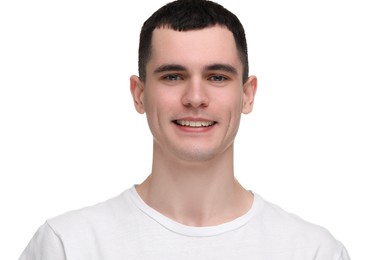 Photo of Handsome young man with clean teeth smiling on white background