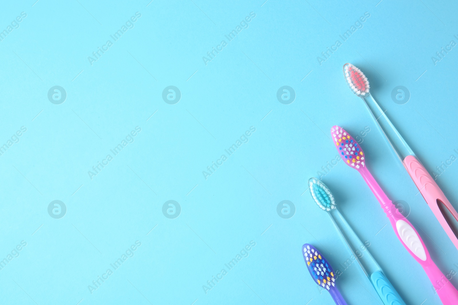 Photo of Flat lay composition with manual toothbrushes on color background