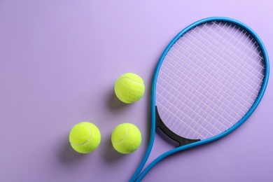 Photo of Tennis racket and balls on violet background, flat lay. Sports equipment
