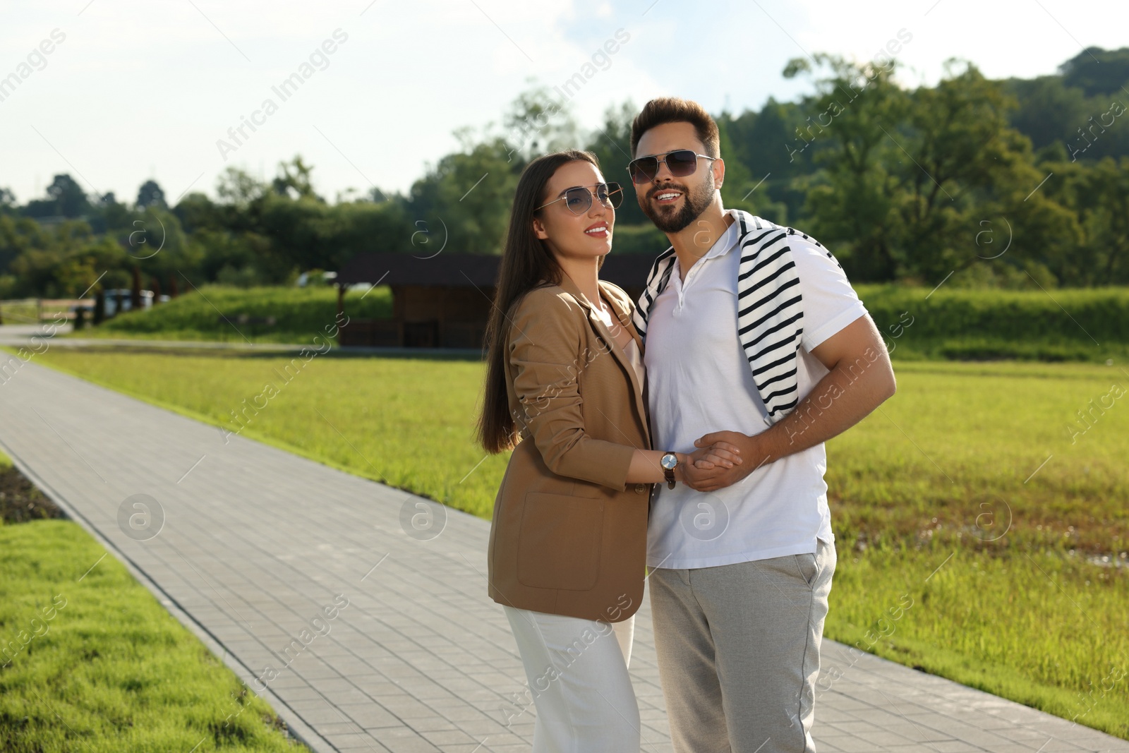 Photo of Romantic date. Beautiful couple spending time together in park, space for text