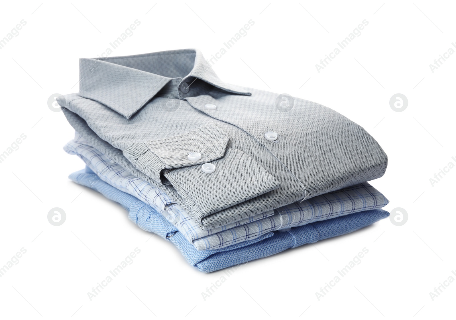 Photo of Stack of stylish male shirts isolated on white