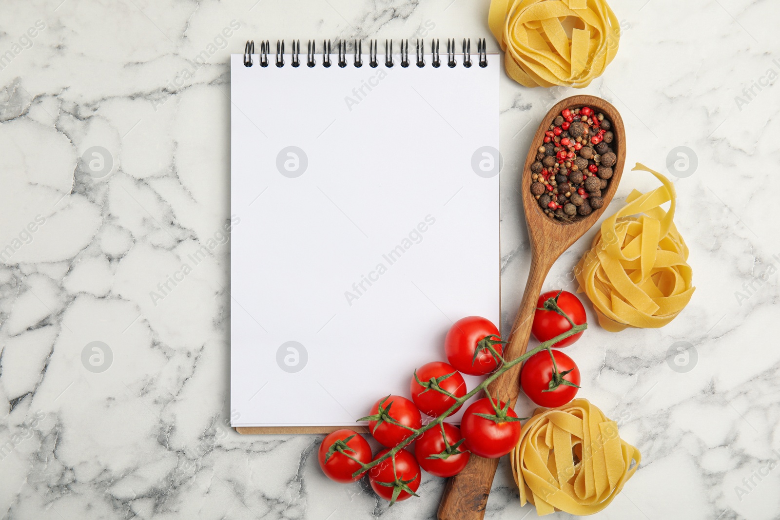 Photo of Recipe book and ingredients on white marble table, flat lay with space for text. Cooking classes