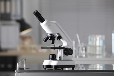 Modern medical microscope on metal table in laboratory