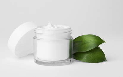 Photo of Jar of cosmetic product on light background