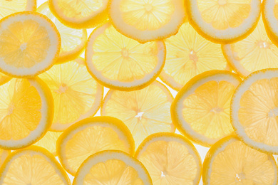 Photo of Slices of fresh lemon as background, top view