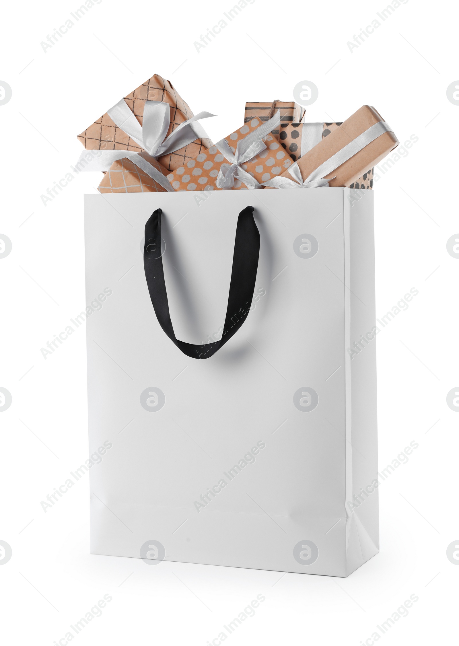 Photo of Paper shopping bag with handles full of gift boxes on white background. Mock up for design