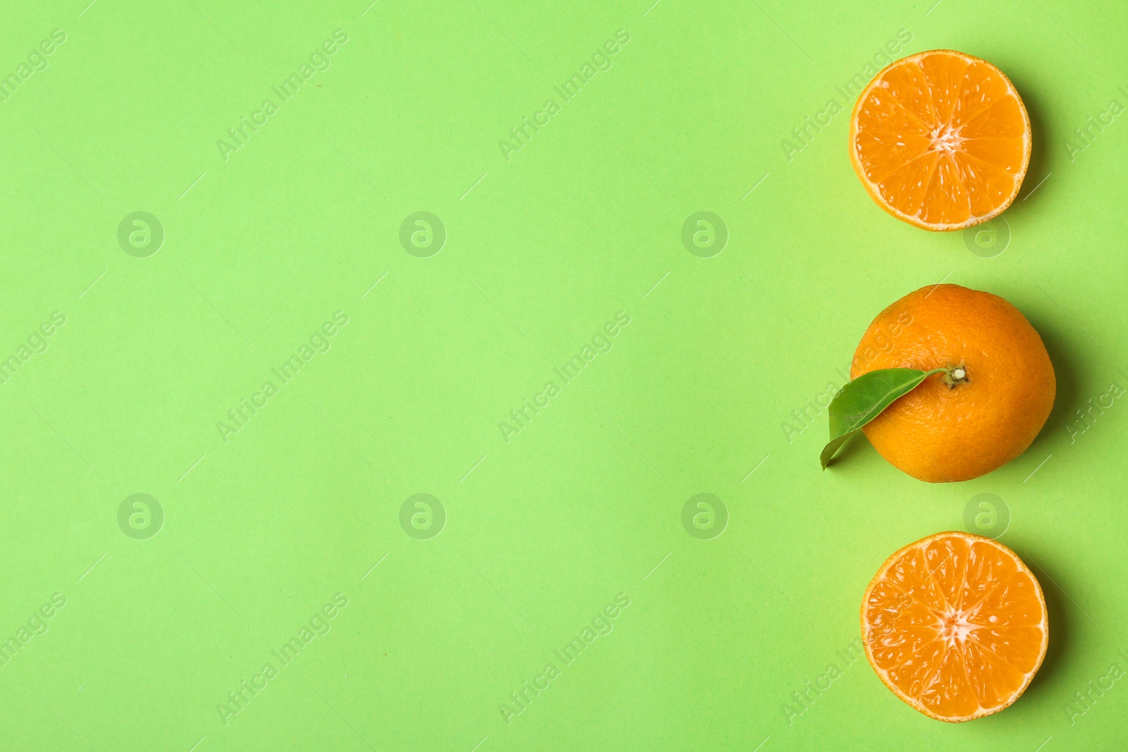 Photo of Composition with tangerines on color background, flat lay. Space for text