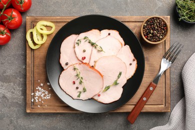 Photo of Delicious cut ham with thyme and spices on grey table, flat lay