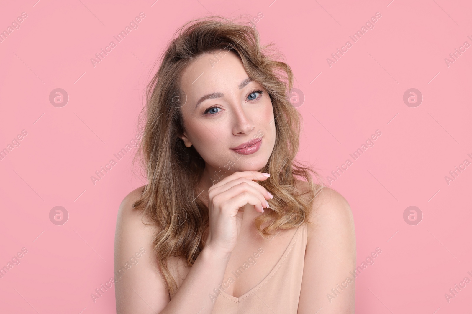 Photo of Portrait of beautiful woman on pink background