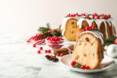 Photo of Composition with piece of traditional homemade Christmas cake on white marble table, closeup. Space for text