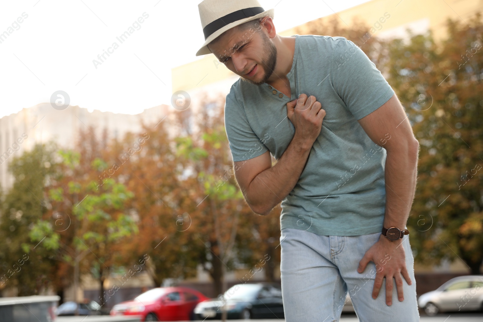 Photo of Man having heart attack on city street