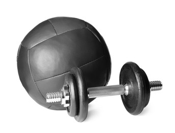 Medicine ball and dumbbell on white background