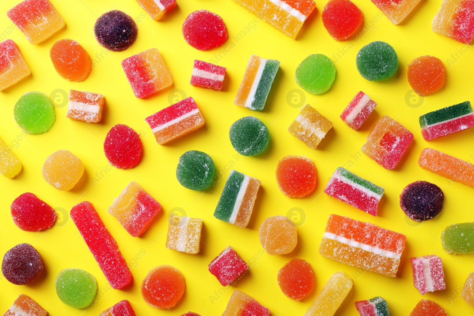 Photo of Flat lay composition with delicious colorful candies on color background