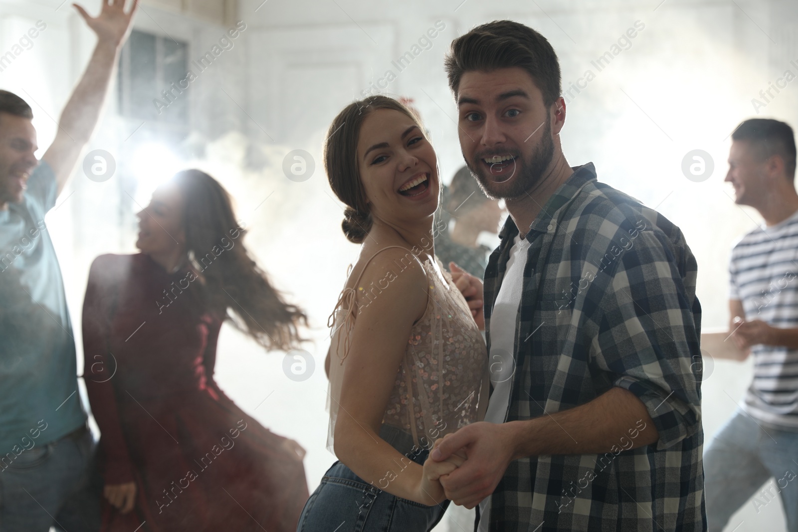 Photo of Lovely young couple dancing together at party