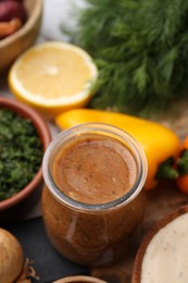 Photo of Fresh marinade in jar on table, closeup