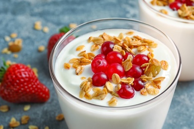 Photo of Glass with yogurt, berries and granola, closeup