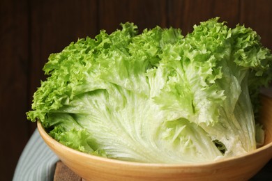 Photo of Fresh lettuce on table, closeup. Salad greens