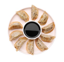 Photo of Delicious gyoza (asian dumplings) and soy sauce isolated on white, top view