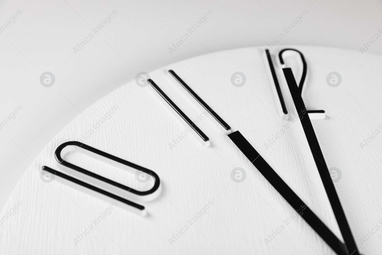 Photo of Stylish analog clock on white background, closeup