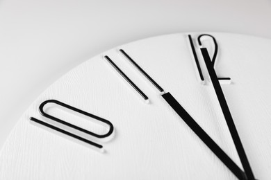 Photo of Stylish analog clock on white background, closeup