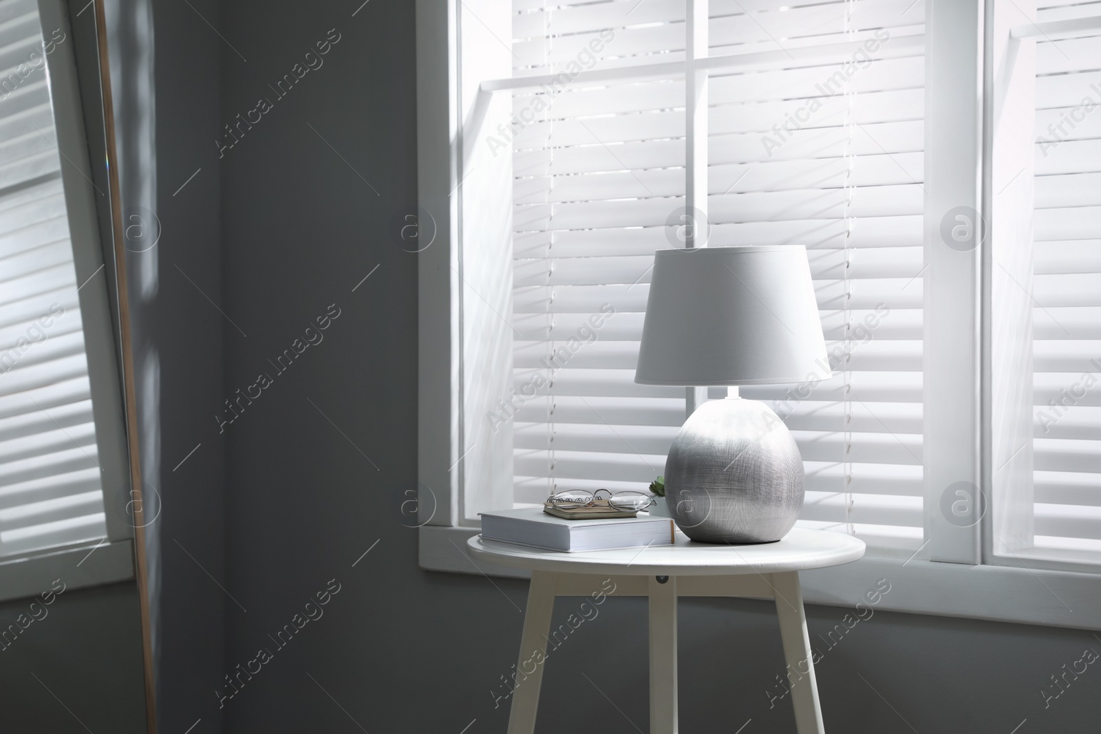 Photo of Room interior with stylish lamp on table, space for text