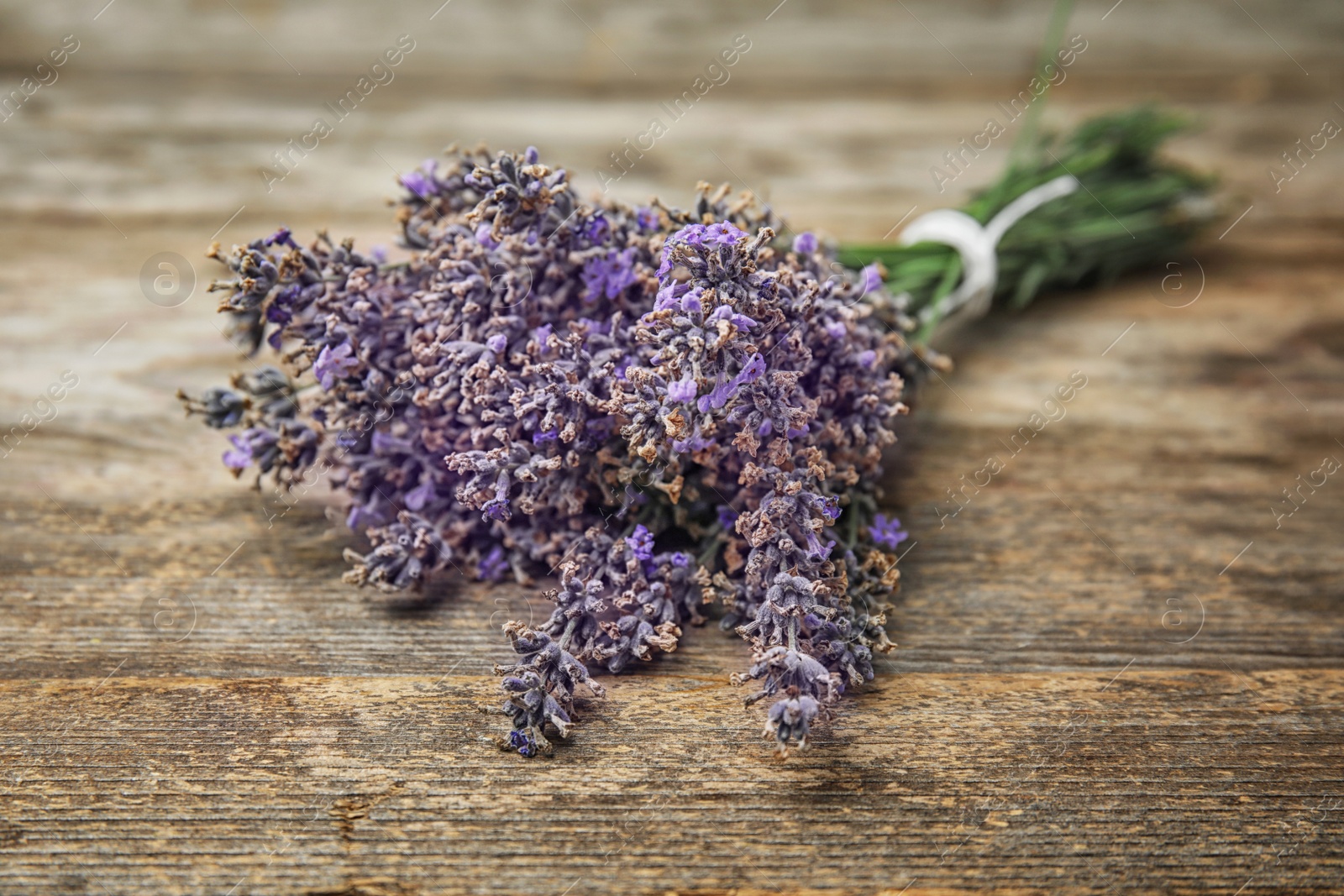 Photo of Beautiful blooming lavender flowers on wooden table