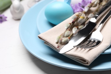 Photo of Festive Easter table setting with egg on white background, closeup