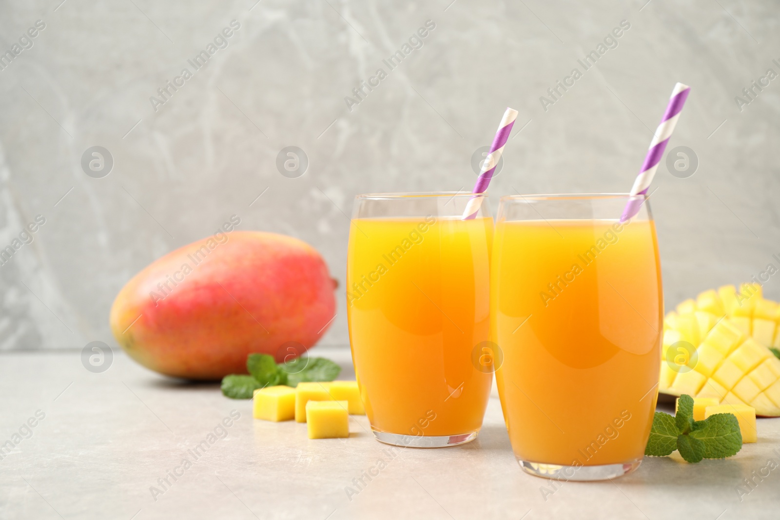 Photo of Fresh delicious mango drink on light table