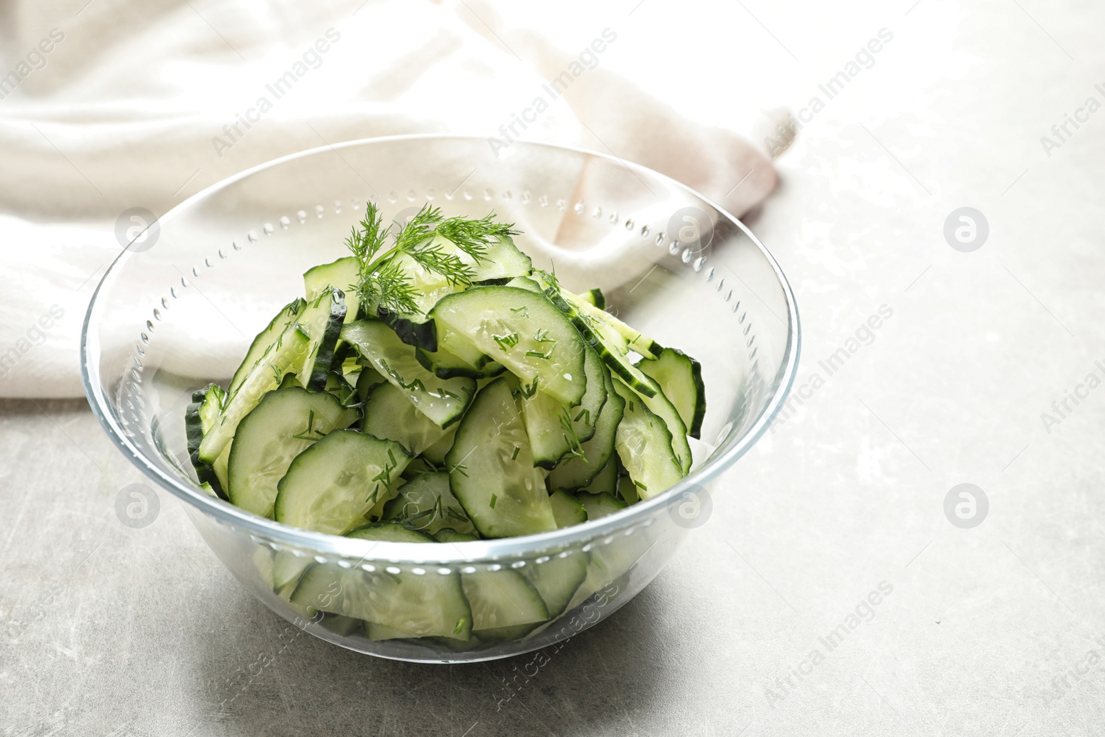 Photo of Delicious cucumber salad with dill in bowl on table