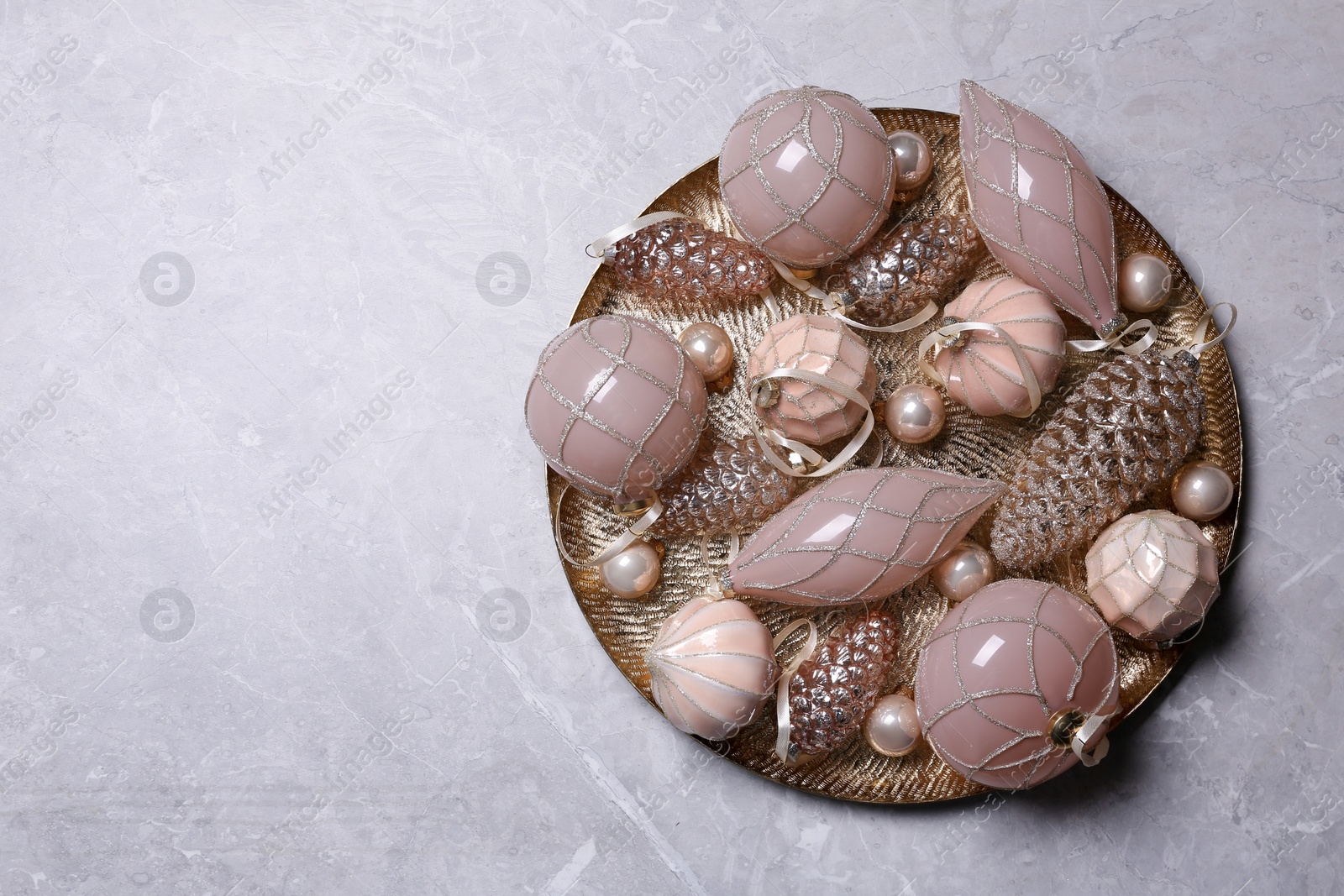 Photo of Christmas baubles on light grey table, top view. Space for text