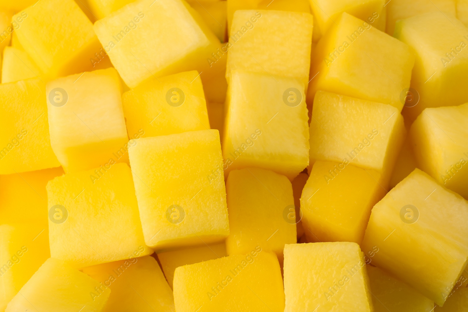 Photo of Many delicious mango cubes as background, closeup