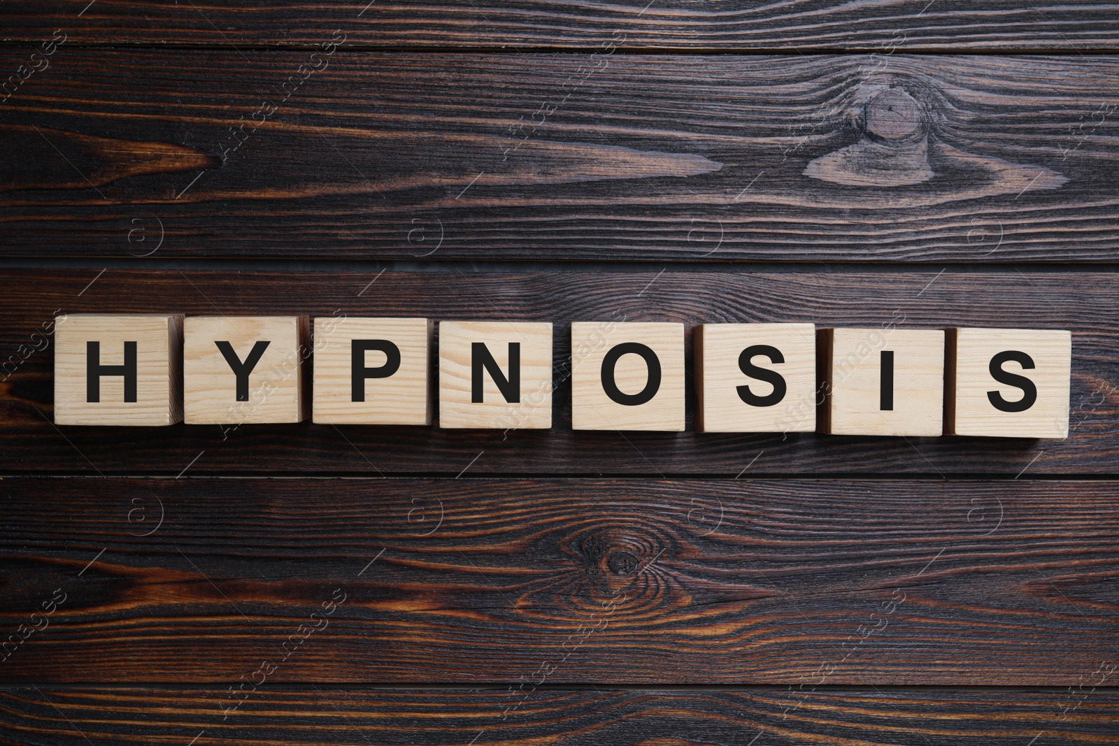 Photo of Blocks with word HYPNOSIS on wooden background, flat lay