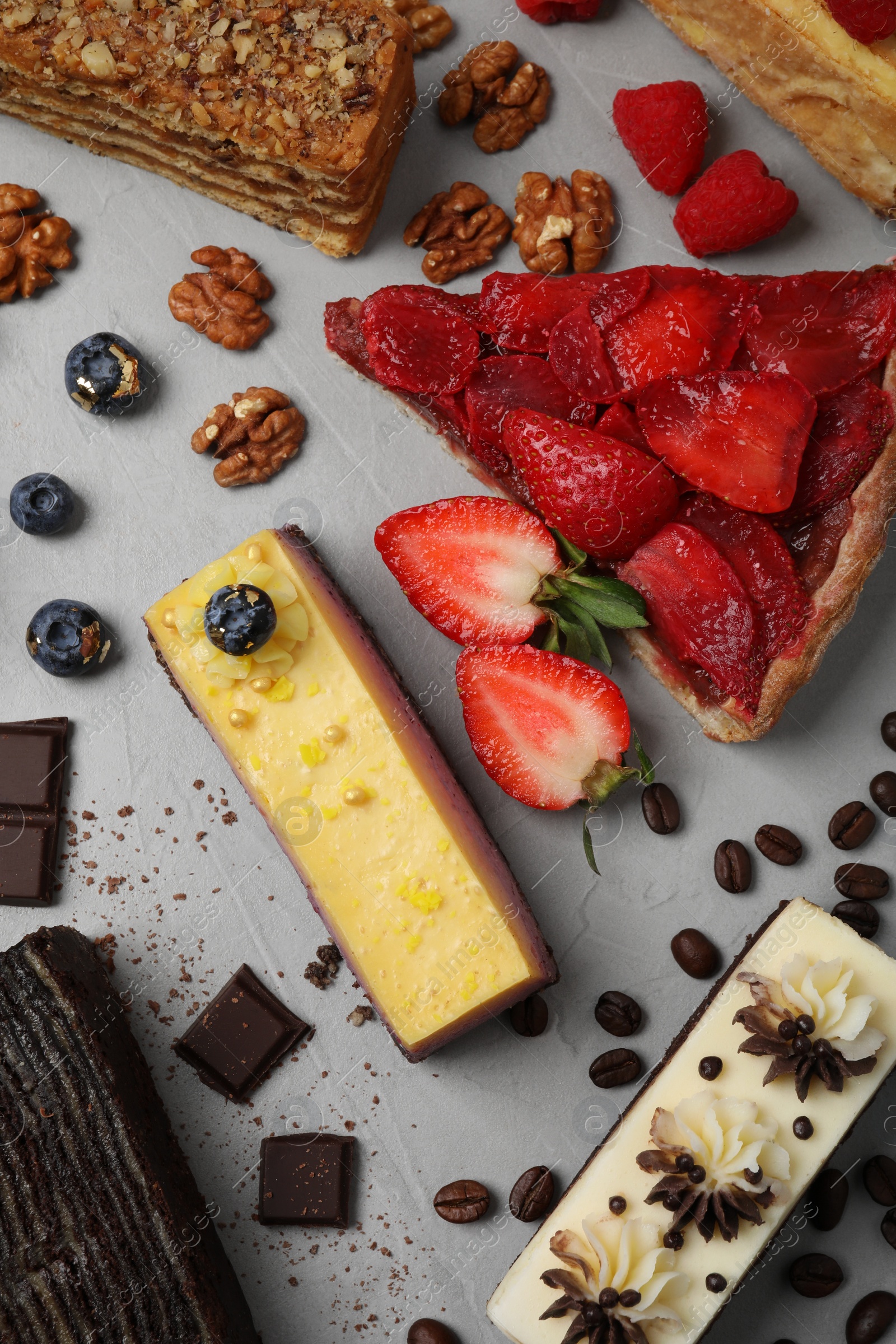 Photo of Flat lay composition with different tasty cakes on light grey table