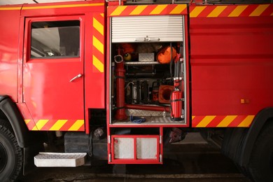 Photo of Red fire truck with safety equipment at station