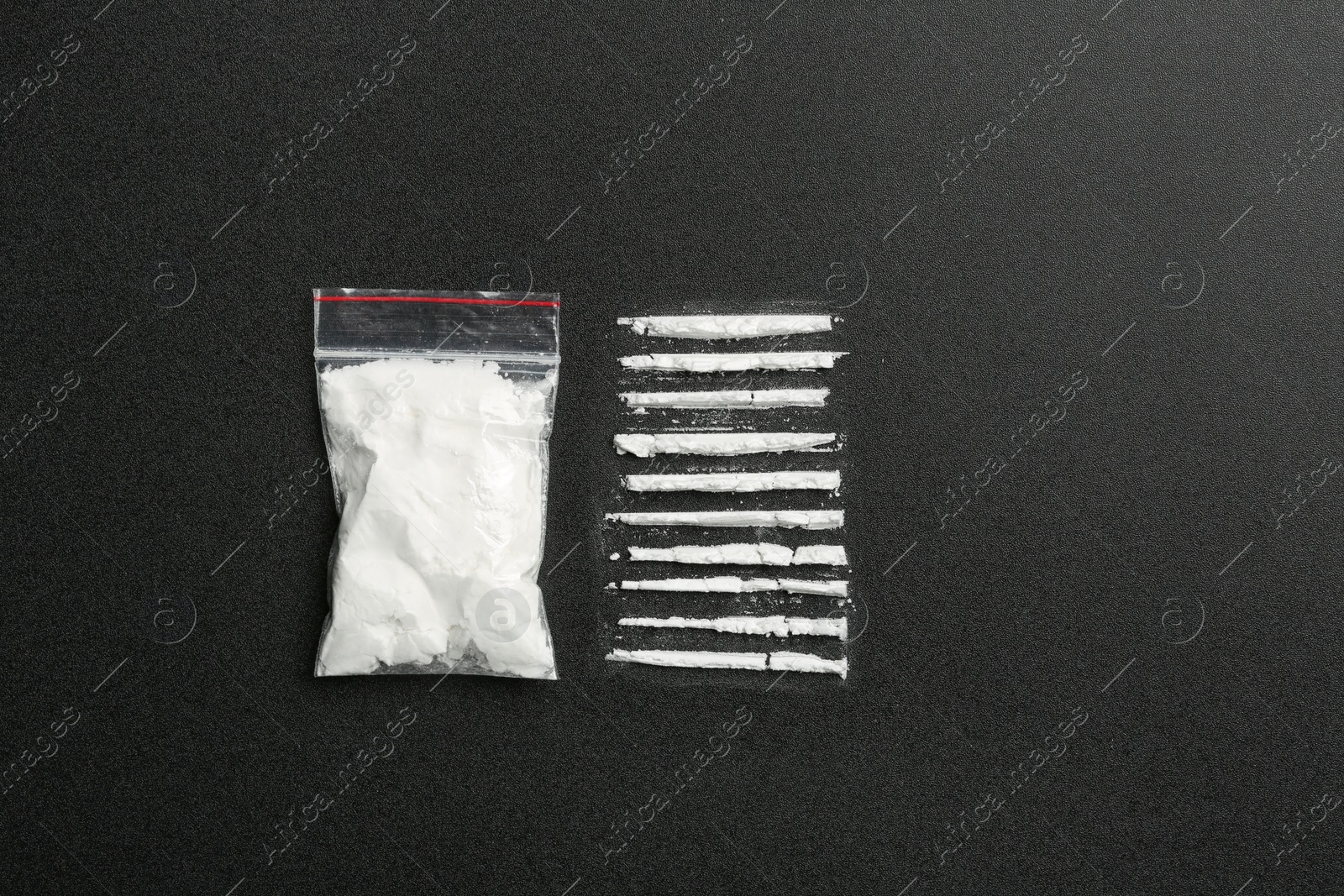 Photo of Flat lay composition with cocaine powder on black background. Space for text