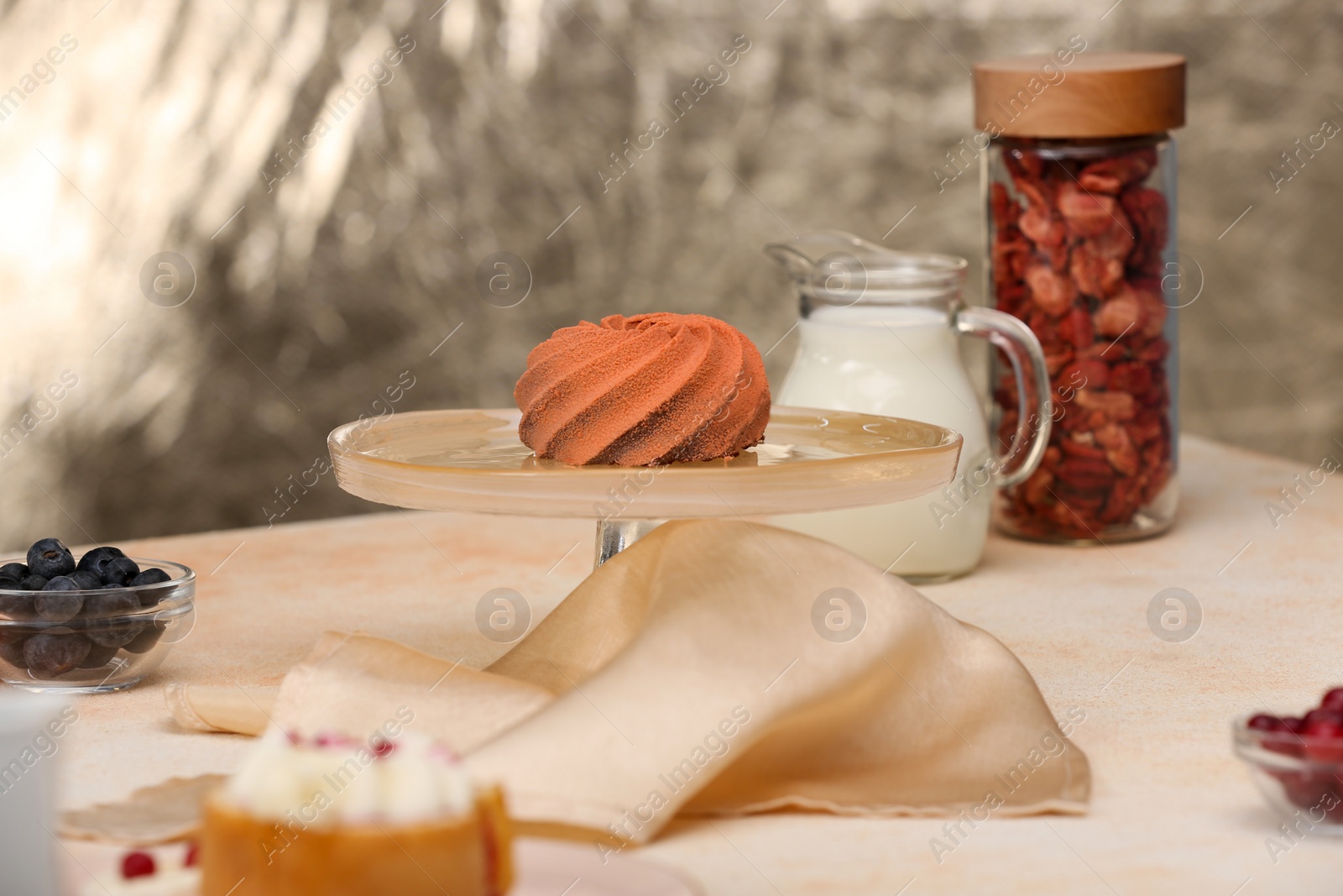 Photo of Beautiful composition of delicious desserts on beige table indoors. Food stylist