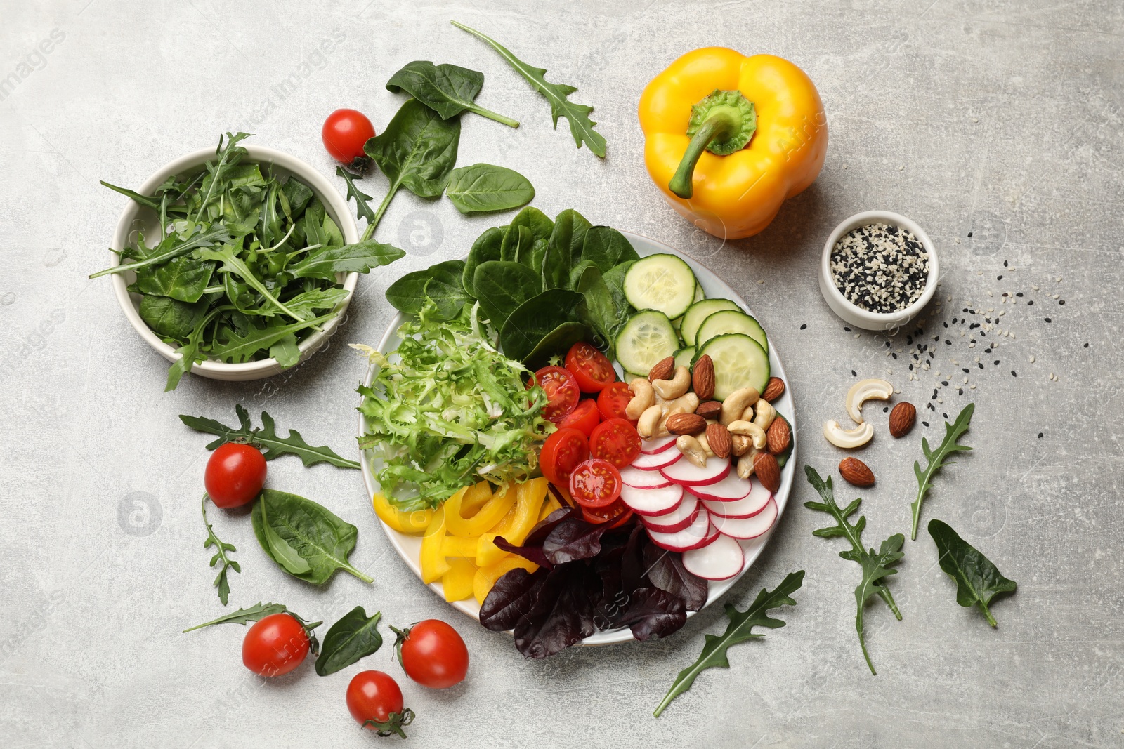 Photo of Balanced diet and vegetarian foods. Plate with different delicious products on grey table, flat lay